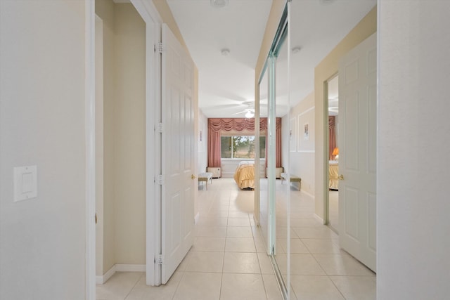 hall featuring light tile patterned floors