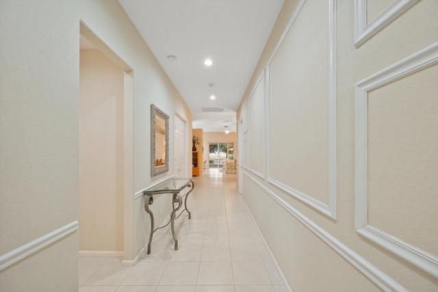 corridor with light tile patterned floors