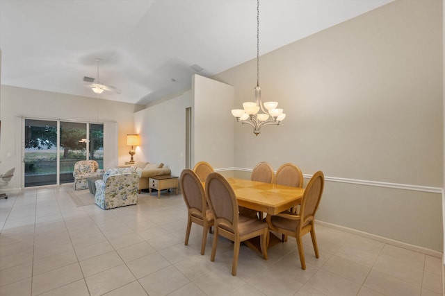 tiled dining area with lofted ceiling and ceiling fan with notable chandelier