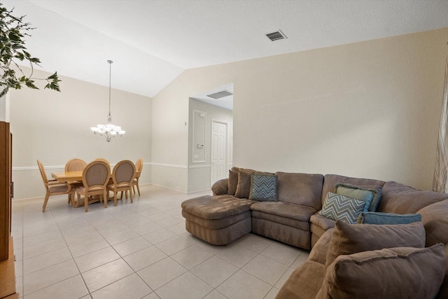 living room with vaulted ceiling, light tile patterned flooring, and a chandelier