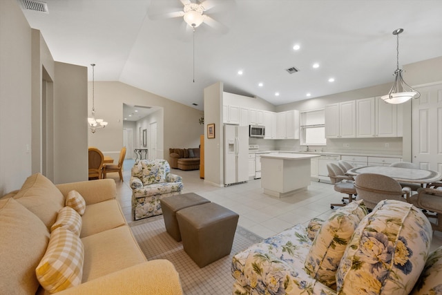 living room with ceiling fan with notable chandelier, lofted ceiling, sink, and light tile patterned floors