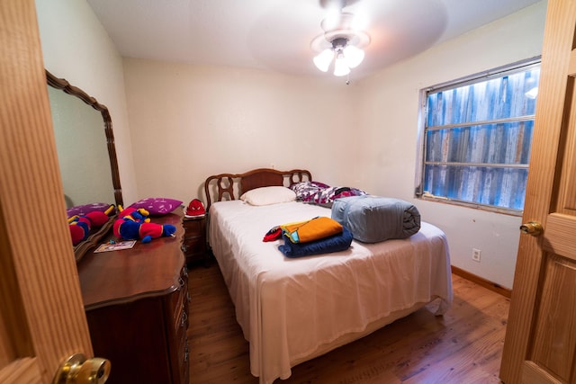 bedroom featuring wood-type flooring and ceiling fan