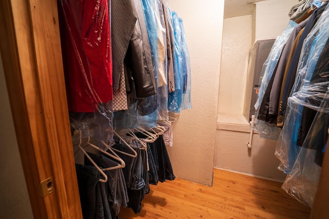 walk in closet with wood-type flooring