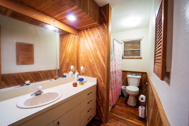 full bath with wooden walls, toilet, wood ceiling, wood finished floors, and vanity