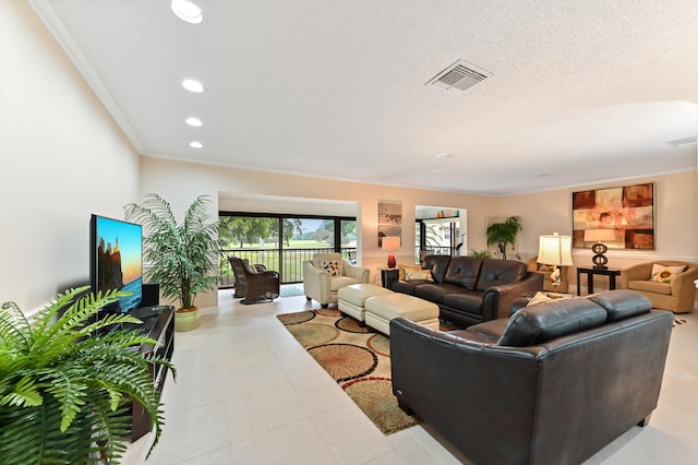 tiled living room featuring ornamental molding and a textured ceiling