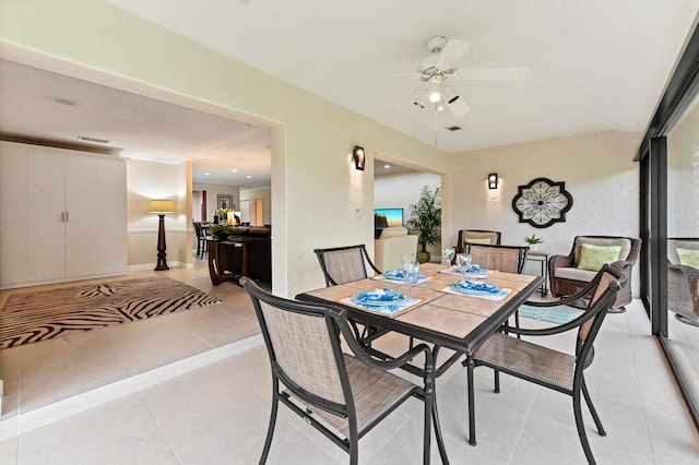 tiled dining room with ceiling fan