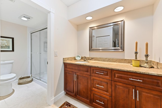 bathroom with tile patterned flooring, vanity, toilet, and a shower with shower door