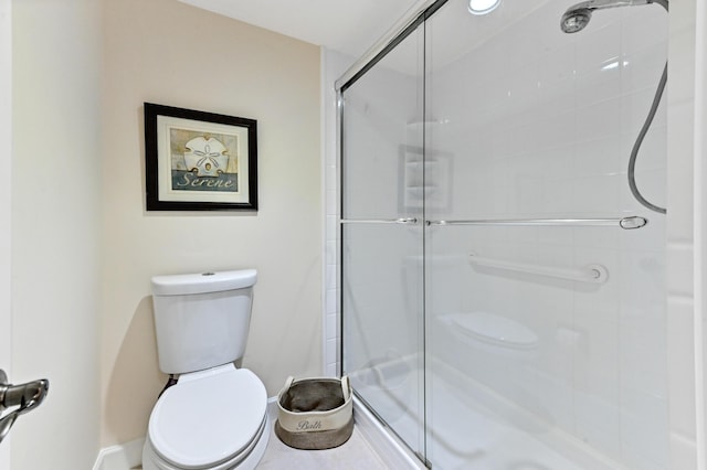 bathroom featuring an enclosed shower and toilet