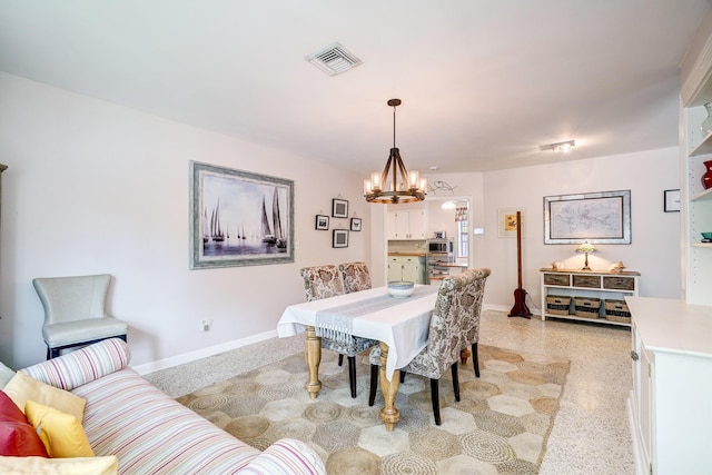 dining space featuring a notable chandelier