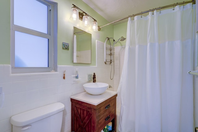 bathroom featuring a wealth of natural light, toilet, and vanity