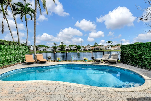 view of pool featuring a water view and a patio