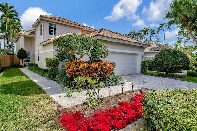 mediterranean / spanish-style home with a garage