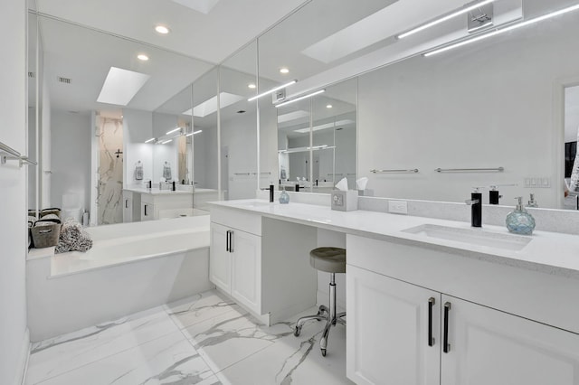 bathroom with vanity, a skylight, and independent shower and bath