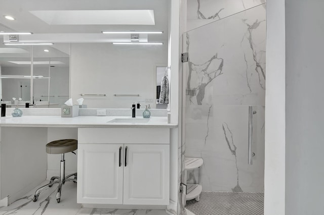 bathroom with a shower with shower door and vanity