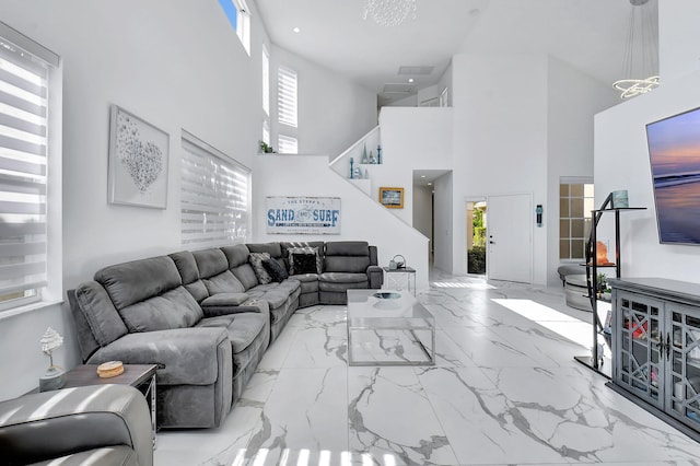 living room with plenty of natural light and a towering ceiling