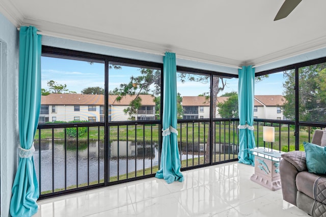 sunroom / solarium with a water view