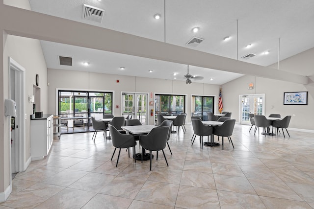 dining space with a wealth of natural light, lofted ceiling, and french doors