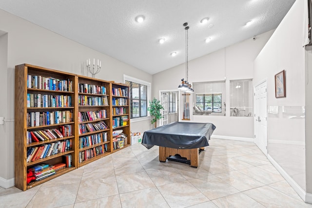 rec room featuring light tile patterned flooring, pool table, a textured ceiling, and lofted ceiling