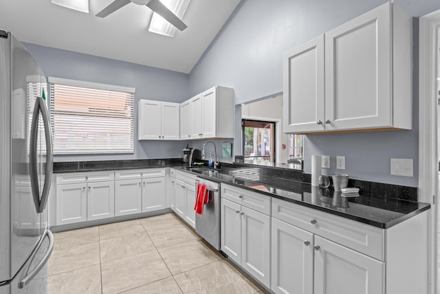 kitchen featuring sink, white cabinetry, lofted ceiling, and appliances with stainless steel finishes