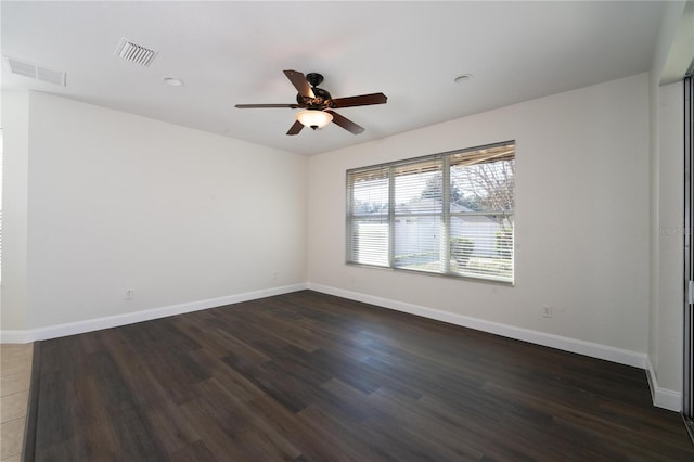 spare room with ceiling fan and dark hardwood / wood-style floors