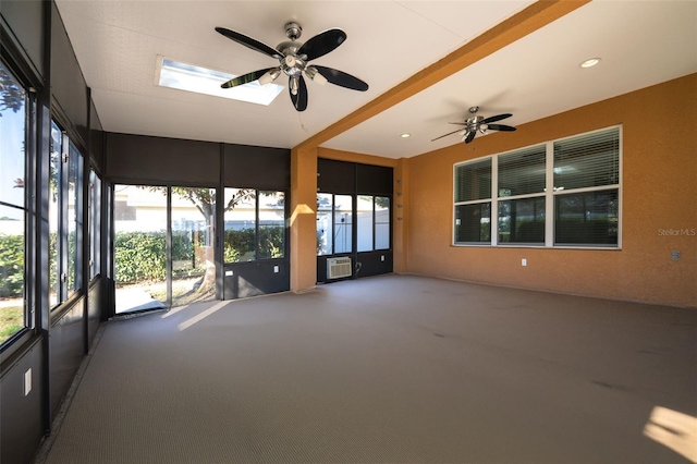 unfurnished sunroom featuring ceiling fan