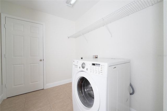 laundry room with light tile patterned flooring and washer / dryer