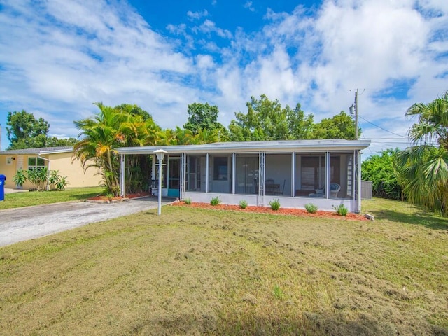 view of front of house featuring a front yard and a sunroom