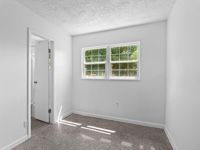 empty room with a textured ceiling