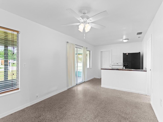 unfurnished living room featuring ceiling fan