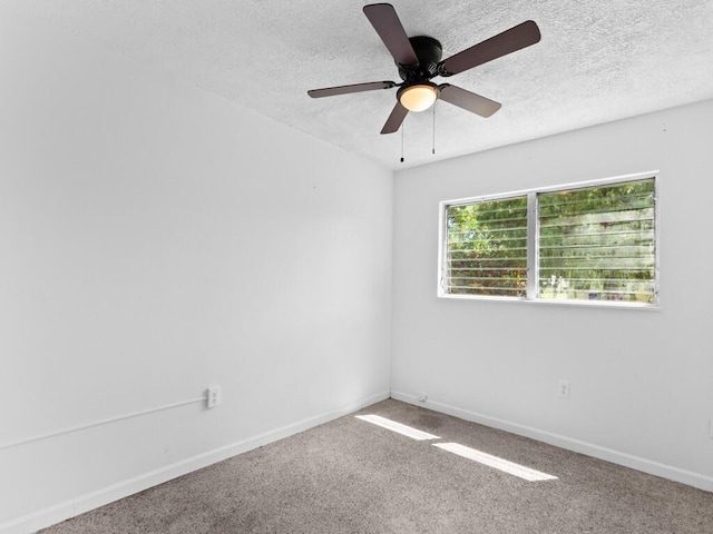 empty room with ceiling fan and carpet