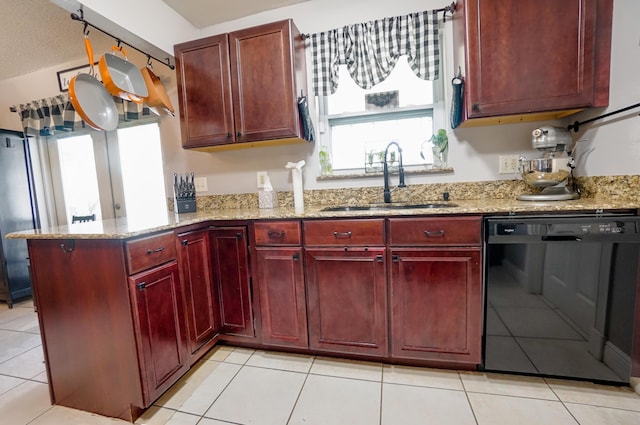 kitchen with black dishwasher, sink, light tile patterned floors, light stone counters, and kitchen peninsula