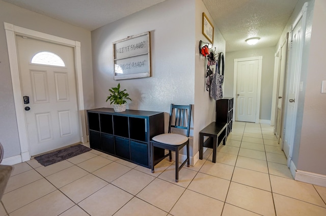 entrance foyer featuring light tile patterned flooring and a textured ceiling