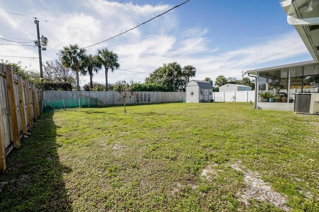 view of yard featuring a storage shed and central air condition unit