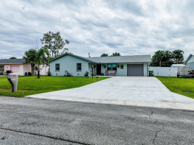 ranch-style home featuring a garage and a front lawn