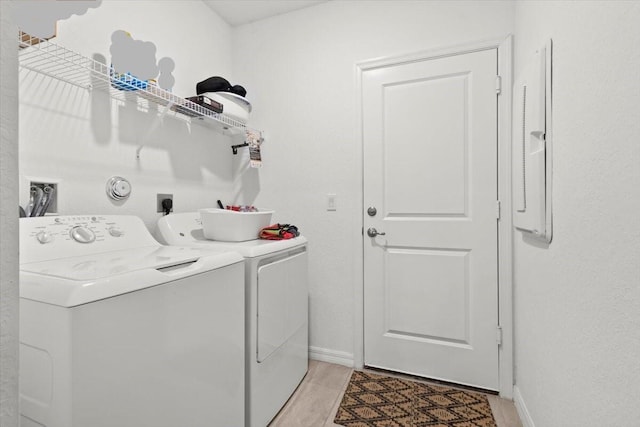 laundry room featuring laundry area, washer and clothes dryer, and baseboards