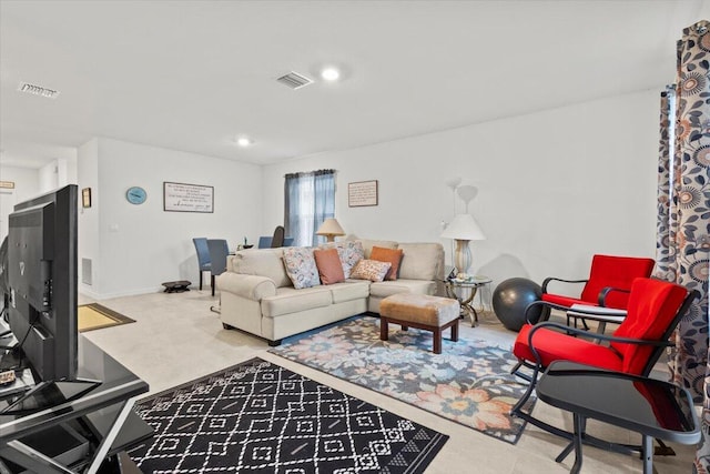 living area featuring baseboards, visible vents, and recessed lighting