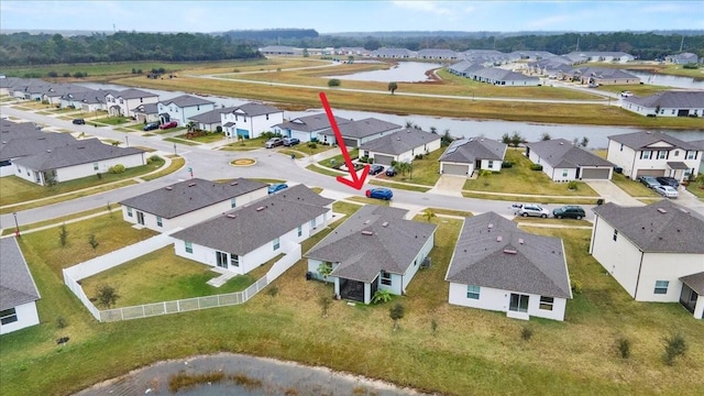 birds eye view of property with a residential view and a water view