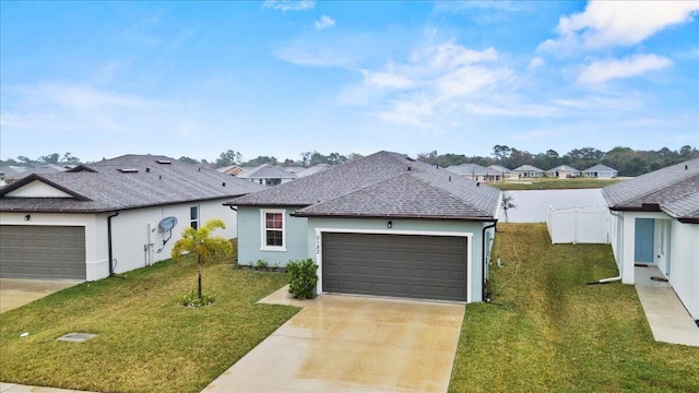 ranch-style house featuring a shingled roof, concrete driveway, fence, a front lawn, and stucco siding