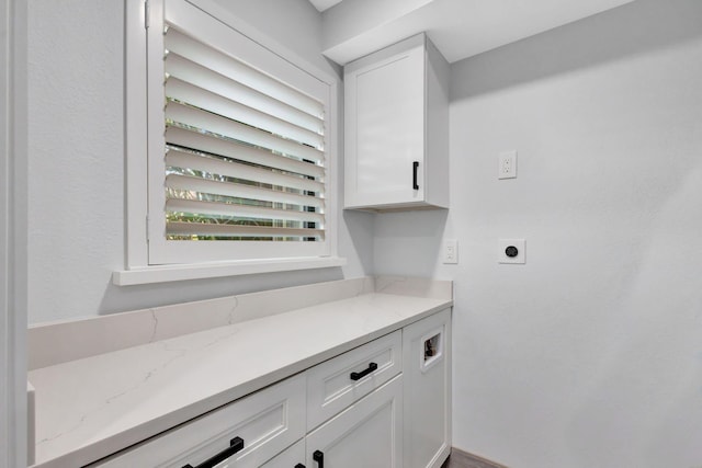 bar featuring white cabinetry and light stone counters