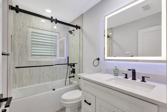 full bathroom with enclosed tub / shower combo, vanity, and toilet