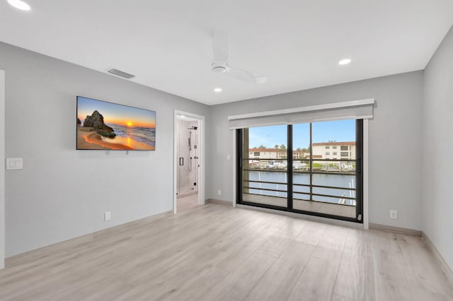 empty room featuring ceiling fan and light wood-type flooring