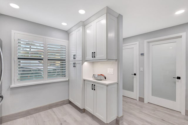 kitchen featuring light hardwood / wood-style floors and white cabinets