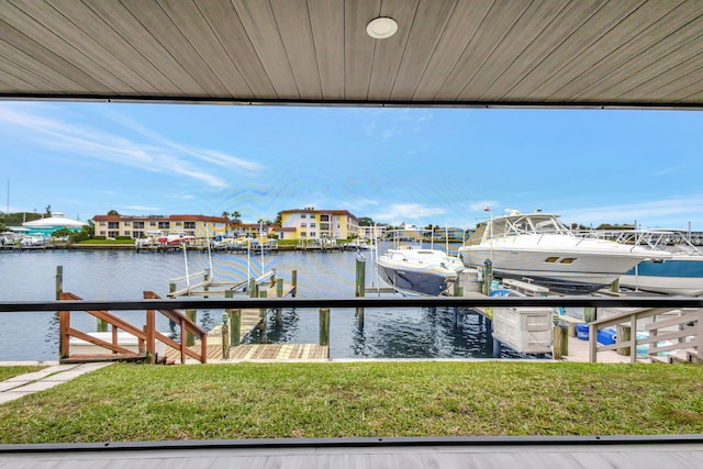 dock area with a water view and a yard