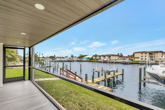 dock area with a yard and a water view