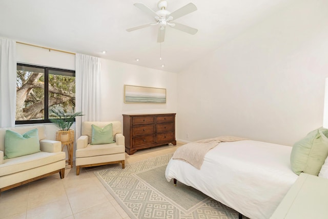 tiled bedroom featuring ceiling fan and vaulted ceiling