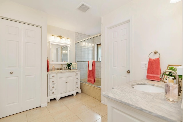 bathroom featuring vanity, tile patterned floors, and shower / bath combination with glass door