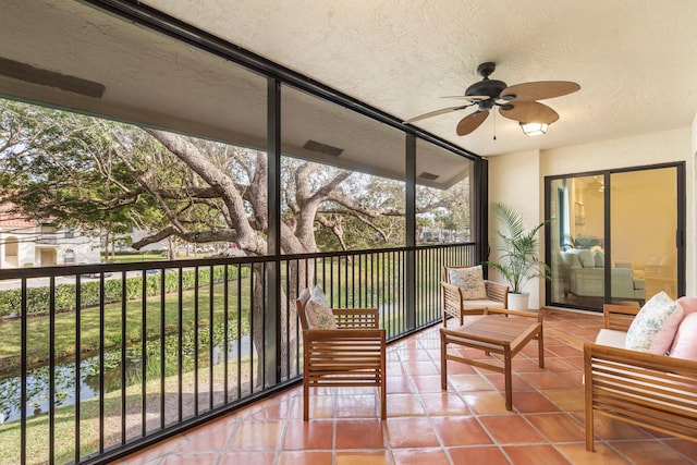 sunroom / solarium featuring ceiling fan