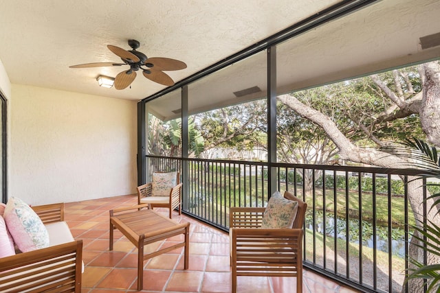 sunroom / solarium with a wealth of natural light and ceiling fan