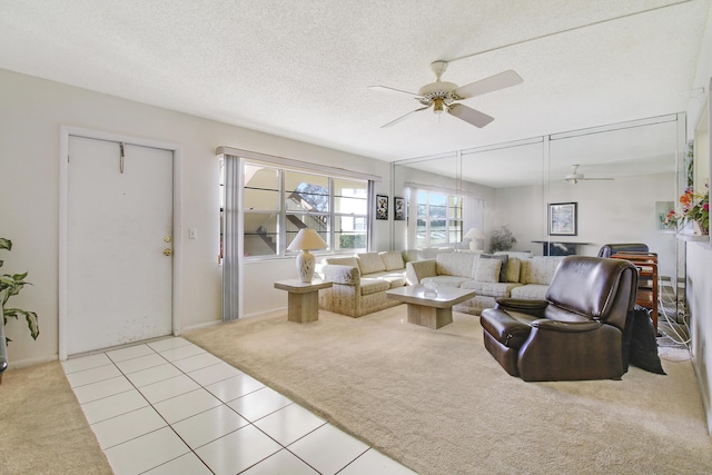 living room with ceiling fan, light colored carpet, and a textured ceiling