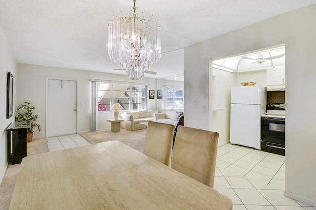 dining area with a chandelier and light tile patterned floors